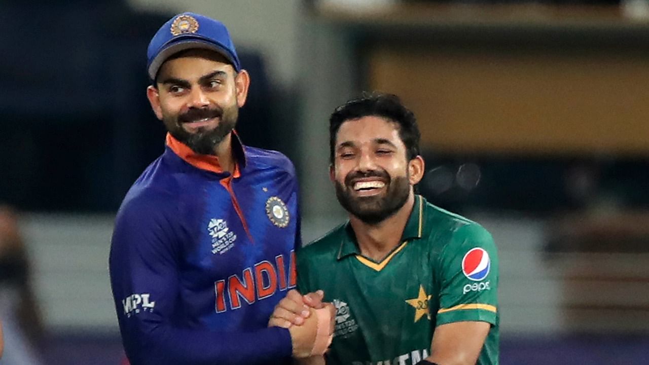 Virat Kohli (L) with Pakistan opener Mohammad Rizwan after India's 10-wicket loss in their T20 World Cup match. Credit: AP/PTI File Photo