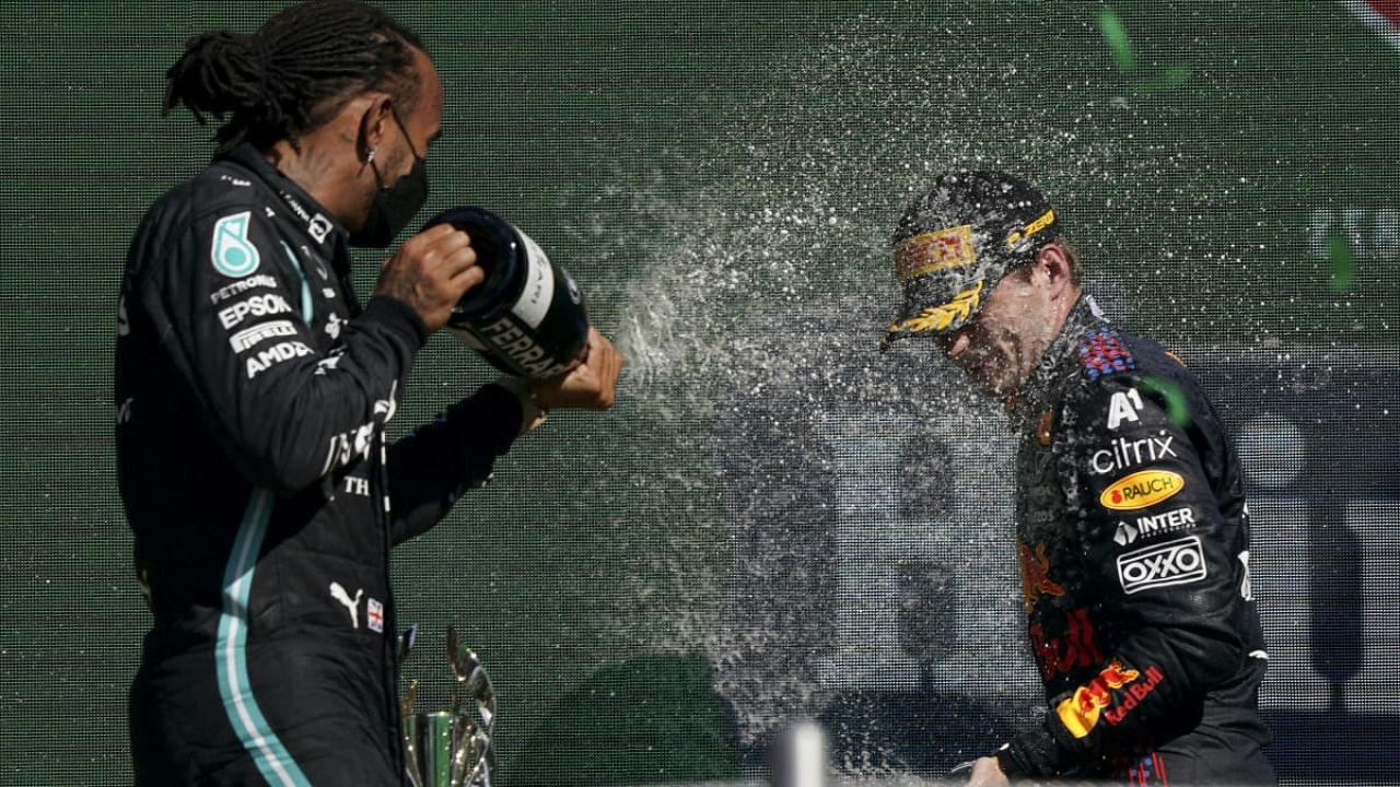 Red Bull's Max Verstappen, right, celebrates winning first place with second placed Mercedes'Lewis Hamilton at the end the Formula One Mexico Grand Prix auto race at the Hermanos Rodriguez racetrack in Mexico City. Credit: AP Photo