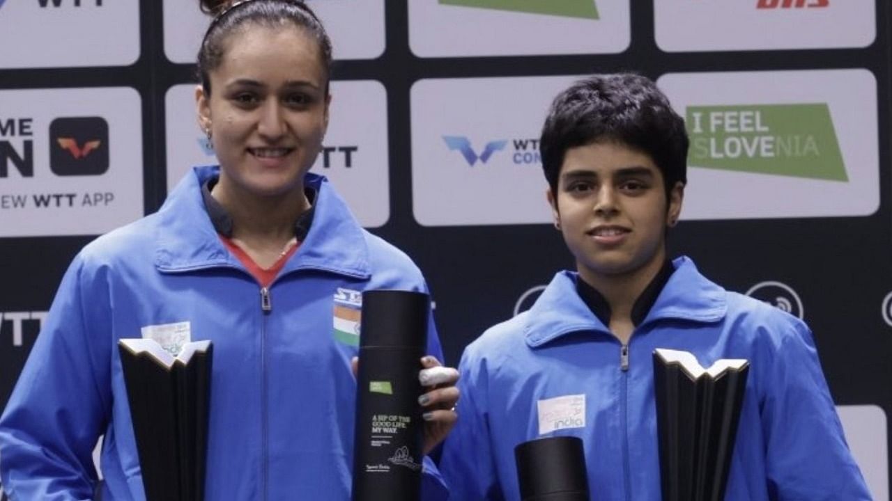 Manika Batra (L) and Archana Kamath pose with the trophy after winning WTT Contender Lasko women's doubles. Credit: IANS Photo