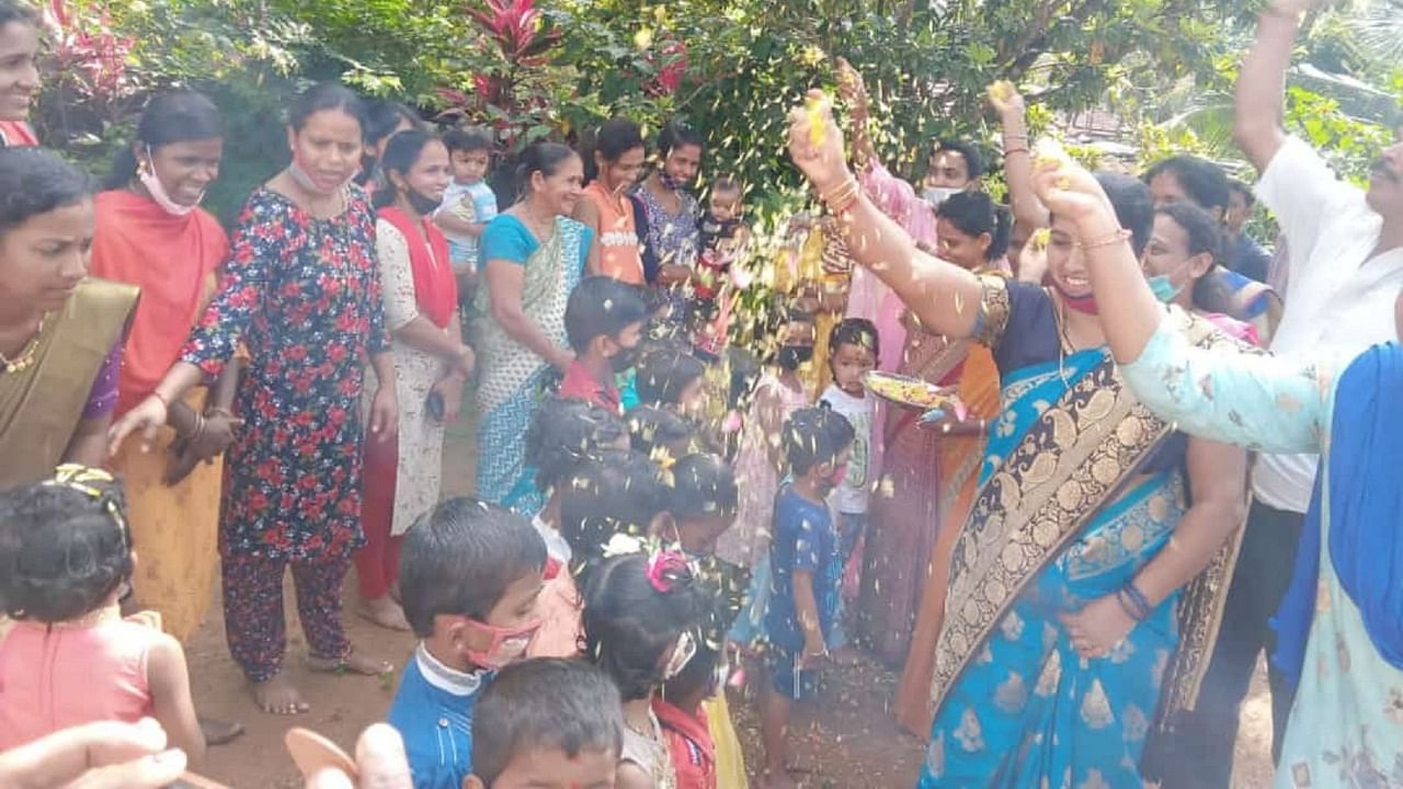 Flower petals showered on kids as they enter the premises of Anganwadi centre at Beeriga in Puttur on Monday. Credit: Special Arrangement