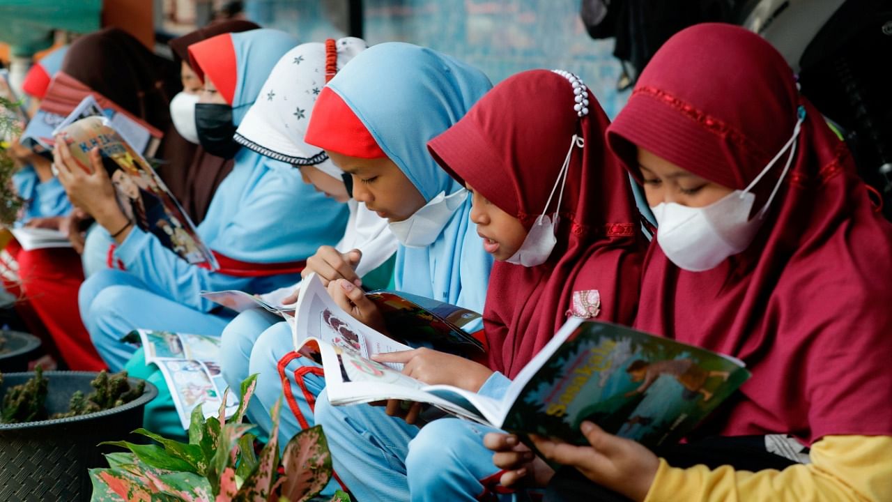 Students read books at a school in Muntang village, Purbalingga, Central Java province, Indonesia. Credit: Reuters Photo