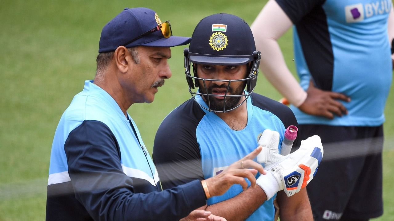 Outgoing India coach Ravi Shastri (L) with opener Rohit Sharma. Credit: AFP File Photo
