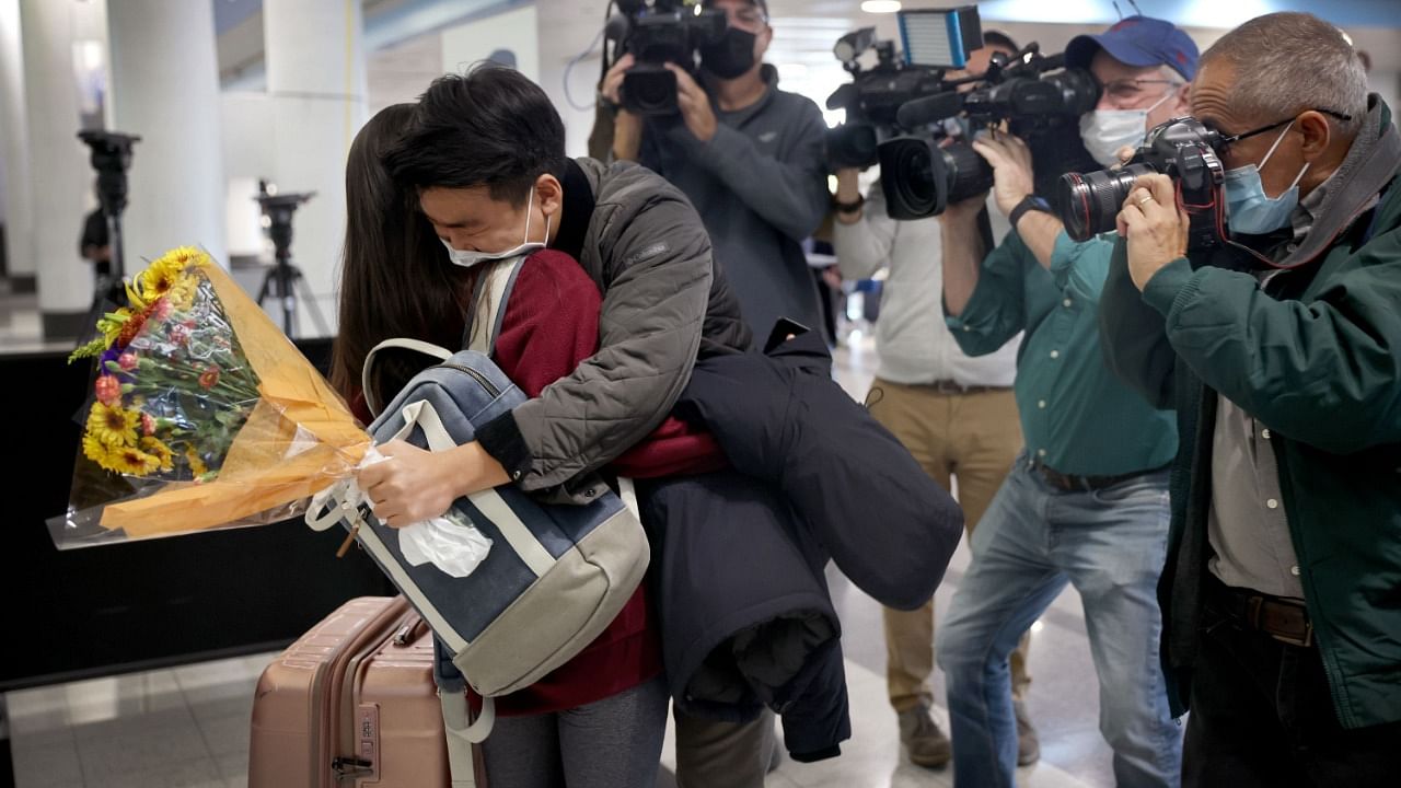News crews gather around as a couple reunites at the international terminal at O'Hare International Airport in Chicago. Credit: AFP Photo