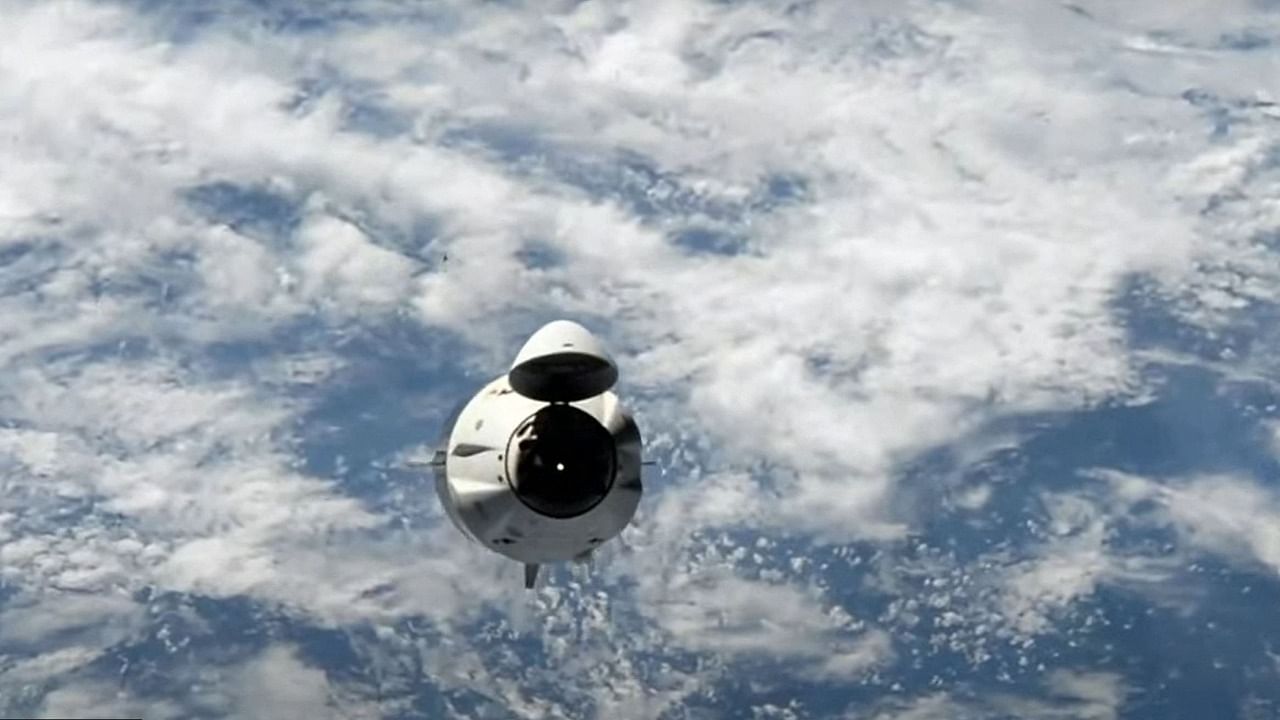 This screengrab taken from the SpaceX live webcast shows a view of the Crew-2 SpaceX Dragon capsule dubbed "Endeavour" as they return to Earth. Credit: AFP Photo