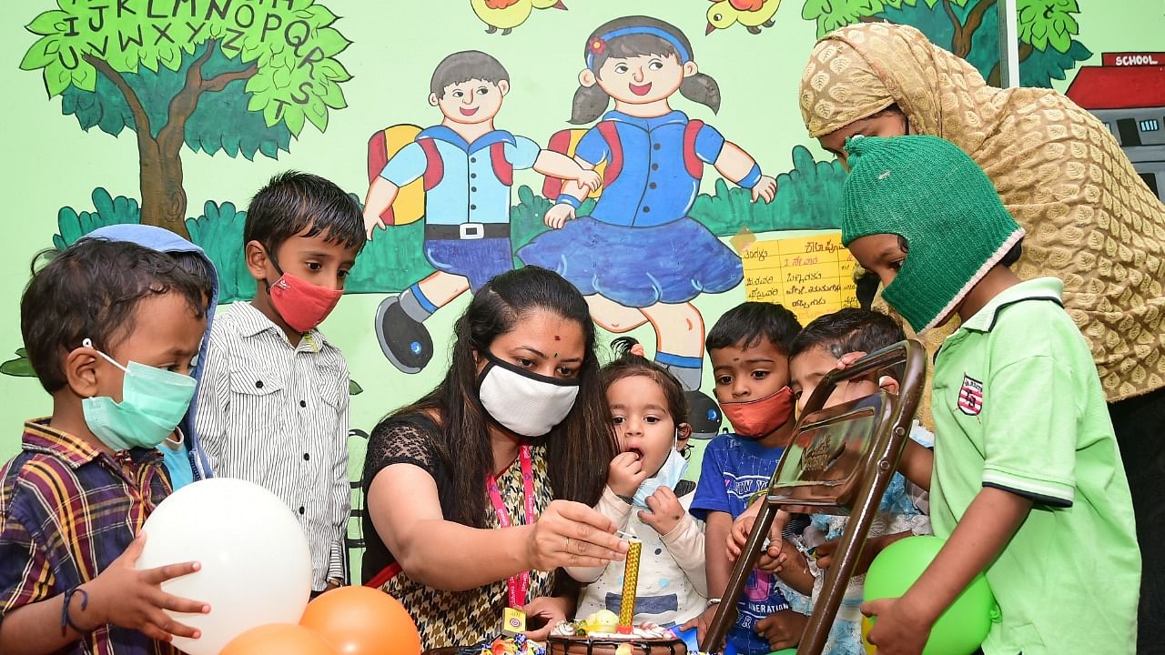 Teachers welcome children at a pre-school in the city on November 8. The pre-schools in the state opened after a gap of several months. Credit: DH Photo/Ranju P