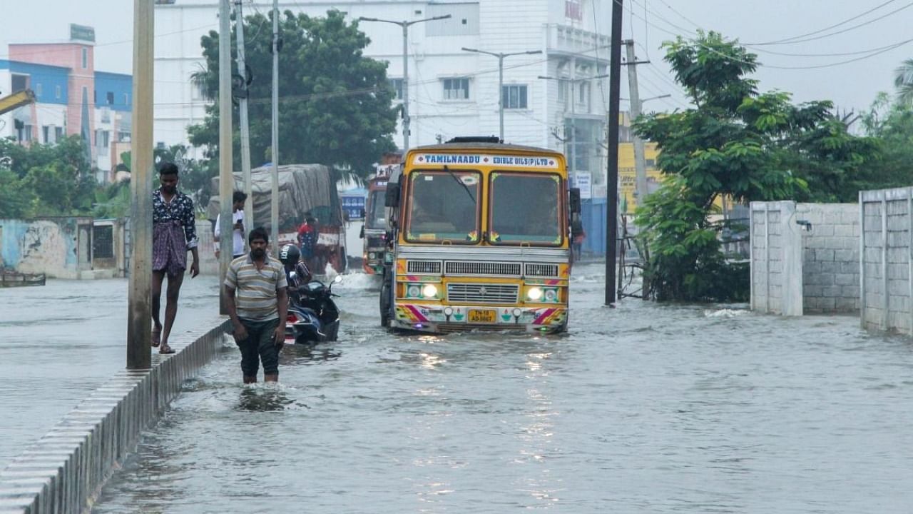 Vehicles stuck in flooded road following heavy rain in Chennai on Tuesday. Credit: IANS Photo