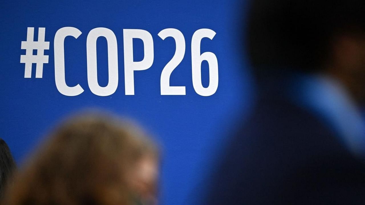 A COP26 sign is pictured during an event on the sidelines of the COP26 UN Climate Change Conference in Glasgow. Credit: AFP Photo