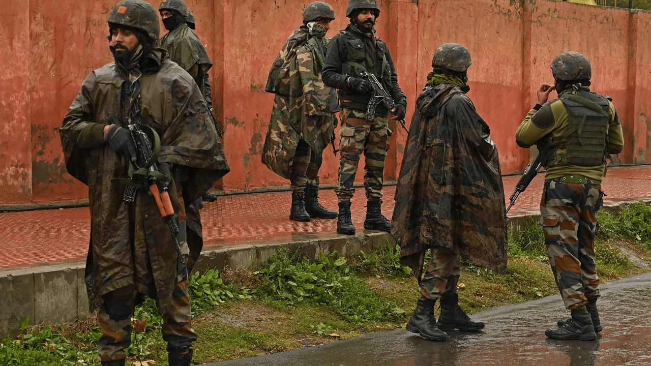 Indian army soldiers stand guard during a search operation. Credit: AFP Photo