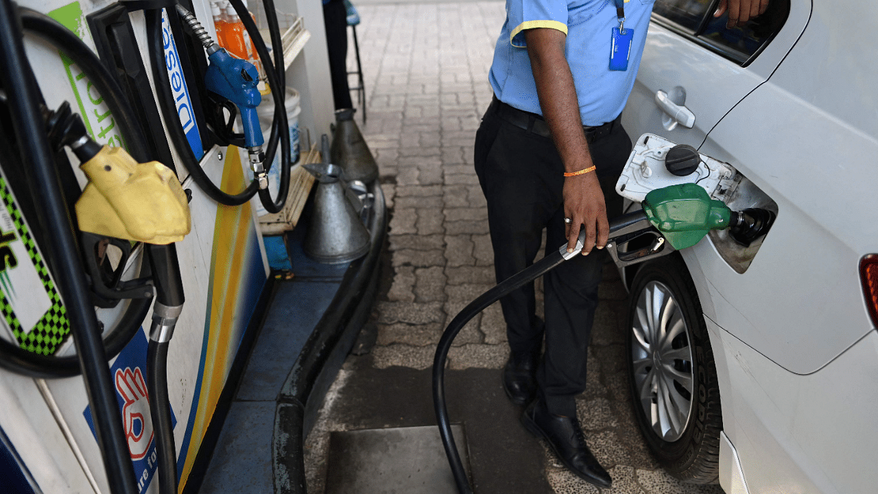 A worker fills up the tank of a car with diesel at a petrol station in New Delhi. Credit: AFP Photo