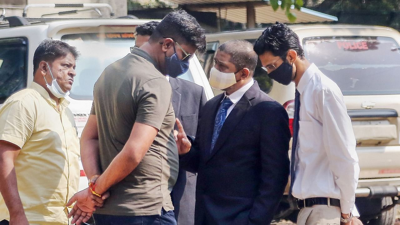 Prabhakar Sail (L), witness in cruise drug bust case, arrives at CRPF camp to appear before NCB vigilance team, in Mumbai, Monday. Credit: PTI Photo