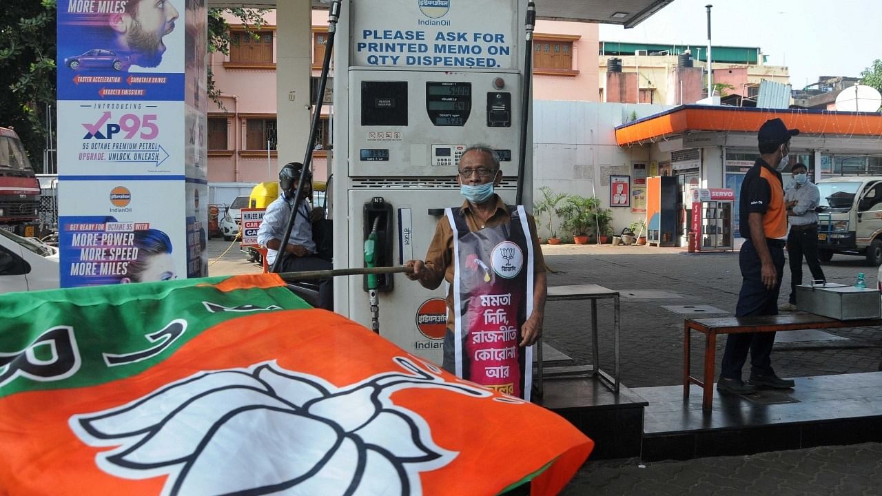 BJP activists take part in a protest against non reduction of VAT on Petrol & Diesel by West Bengal Government at Petrol pump in Kolkata. Credit: IANS