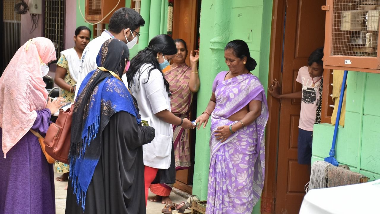 Health workers conducting a door to door survey during in Chamarajpet in Bengaluru. Credit: DH File Photo/B K Janardhan