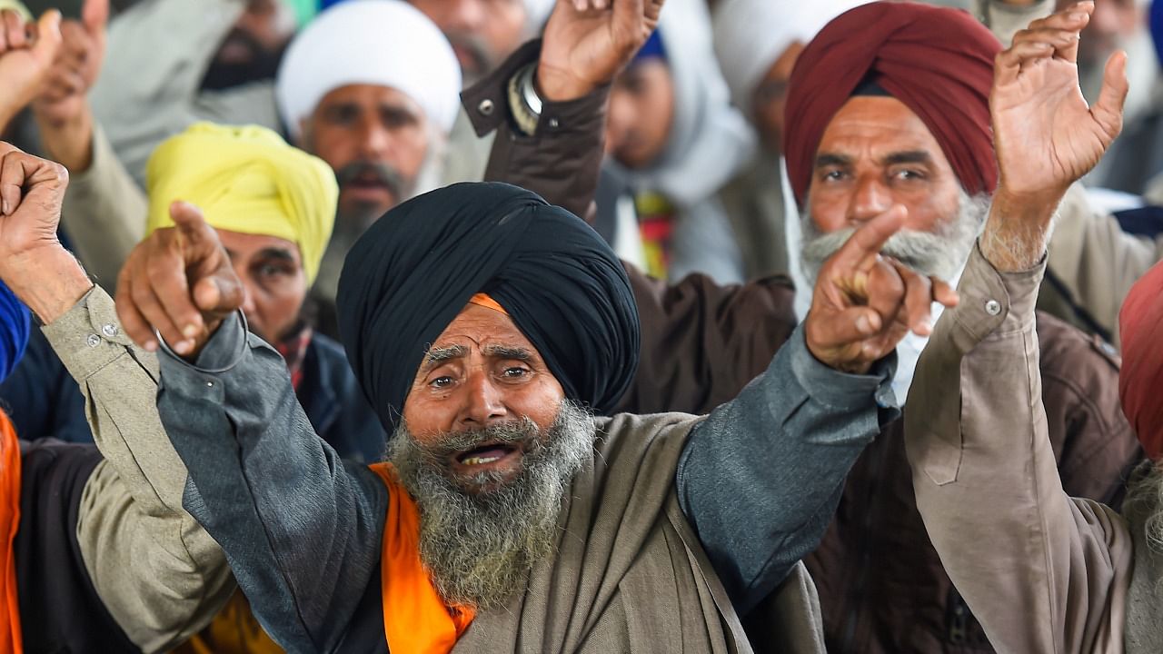 Farmers raise slogans during their ongoing agitation against Centre's farm reform laws, at Singhu border in New Delhi, Thursday, February 4, 2021. Credit: PTI Photo