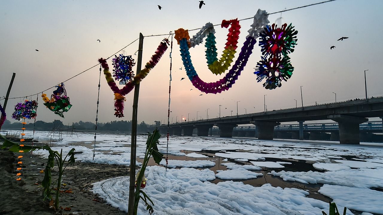 Preparation for 'Chhath Puja' festival even as froth floats in the polluted Yamuna river, at Kalindi Kunj in New Delhi. Credit: PTI Photo