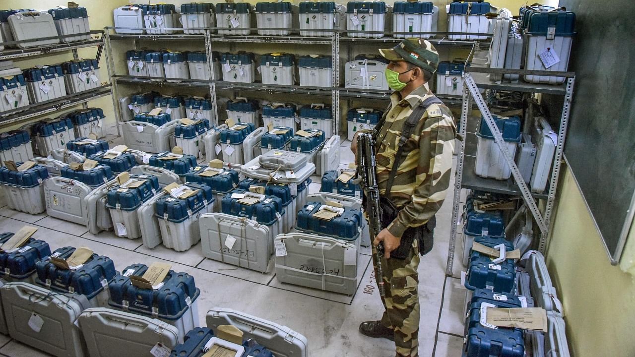 A security person guards a strong room, where Electronic Voting Machine (EVMs) are kept, after the first phase of Bihar Assembly elections at AN College, in Patna, Thursday, October 29, 2020. Credit: PTI File Photo
