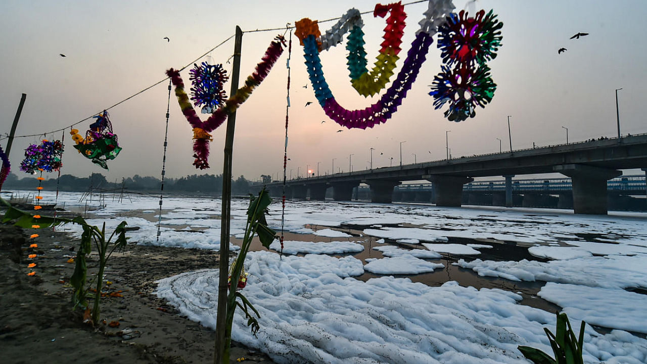 Preparation for 'Chhath Puja' festival even as froth floats in the polluted Yamuna river, at Kalindi Kunj in New Delhi. Credit: PTI Photo