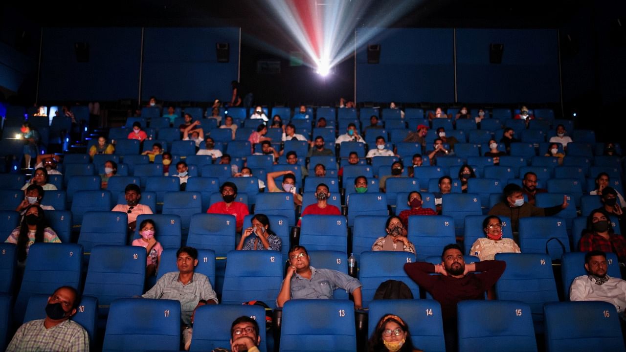 People watch a movie inside a cinema in Mumbai. Credit: Reuters Photo