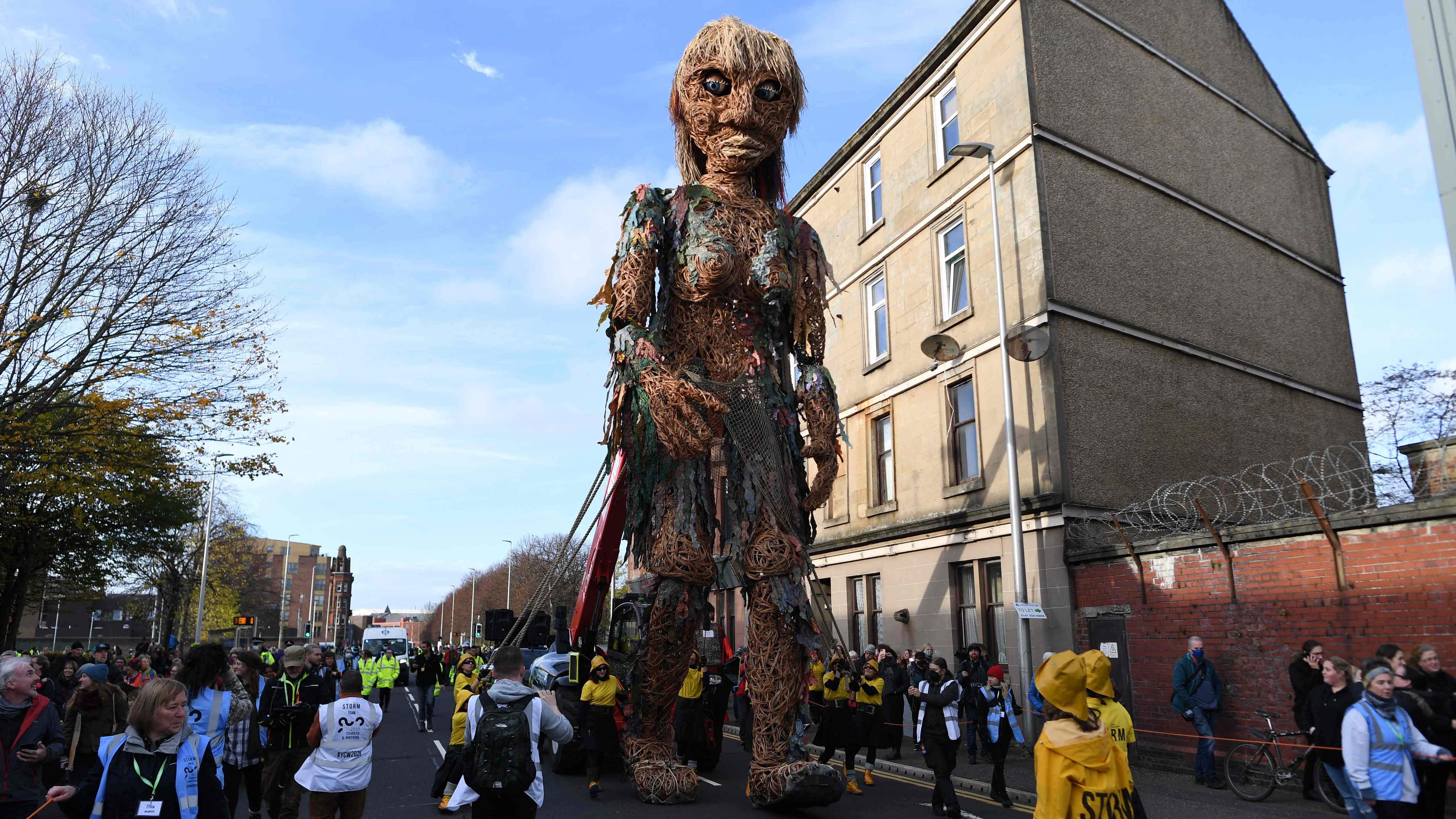 Storm, a 10 metre tall ‘goddess of the sea’ puppet who carries a message of the oceans in crisis, moves through the streets of Glasgow on November 10, 2021, during the COP26 UN Climate Change Conference. Credit: AFP File Photo