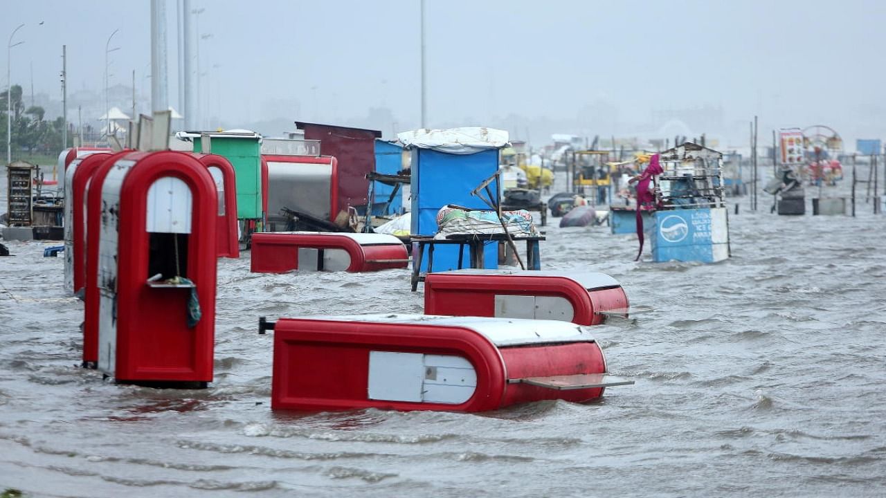 Damaged kiosks are seen on the flooded Marina beach after heavy rains in Chennai. Credit: Reuters Photo