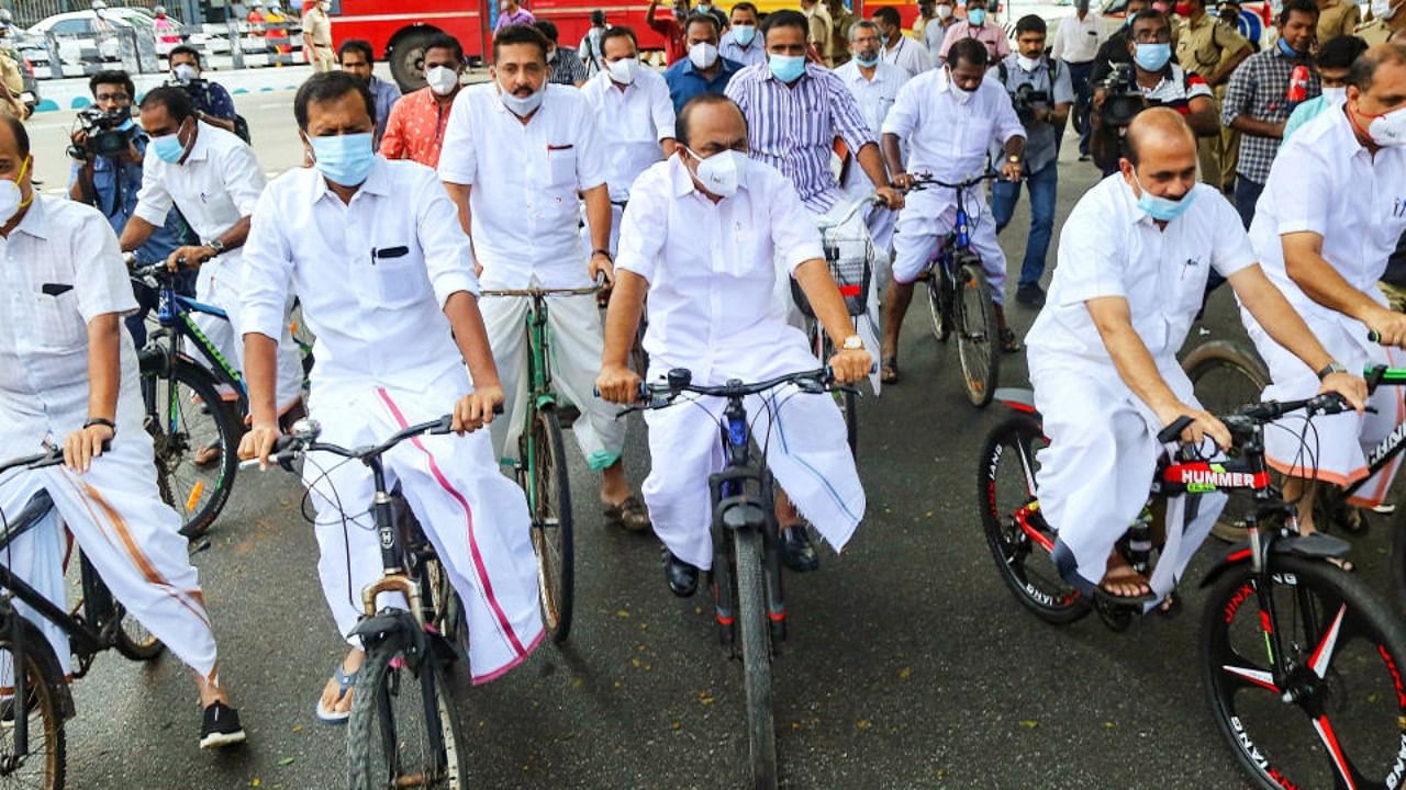 UDF legislators led by V. D. Satheeshan, Leader of the Opposition in the Kerala Assembly, arrive at the Assembly on bicycles to protest against the state government's refusal to slash sales tax on fuel, in Thiruvananthapuram, Thursday, Nov 11, 2021. Credit: PTI Photo