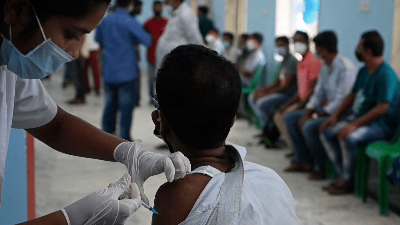 A health worker inoculates a man with a dose of the Covid-19 coronavirus vaccine. Credit: AFP Photo