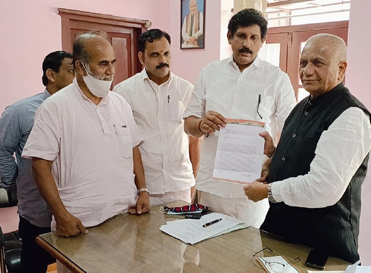A delegation, led by Kannur district BJP unit president N Haridas, submits a memorandum to MLA K G Bopaiah in Virajpet.