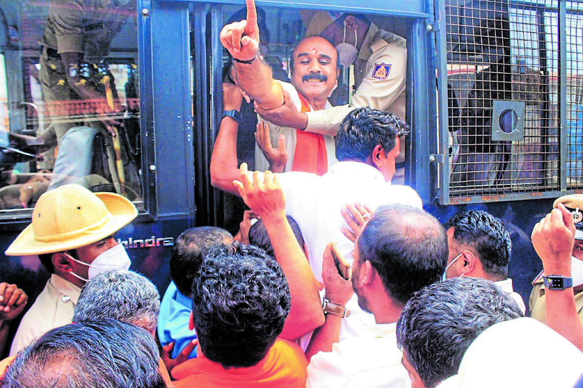 Police take Vishwa Hindu Parishad district president P Krishnamurthy into custody near Omkareshwara Temple in Madikeri.