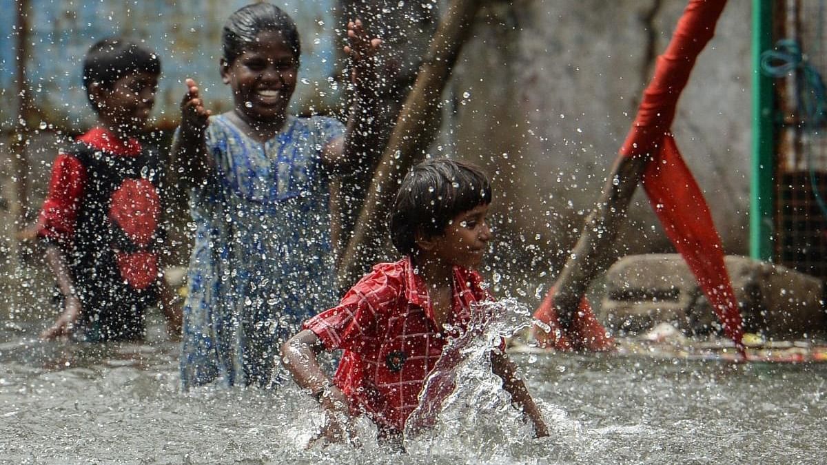 Children play at a waterlogged street near a residential area after heavy monsoon rainfall in Chennai. Credit: AFP Photo