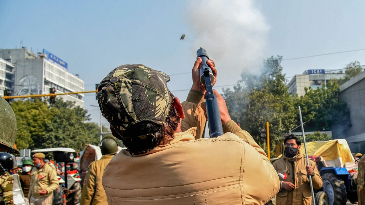 Police fire teargas shells to disperse protesting farmers who were attempting to break barricades at ITO during their 'tractor march' on Republic Day, in New Delhi, Tuesday, January 26, 2021. Credit: PTI File Photo