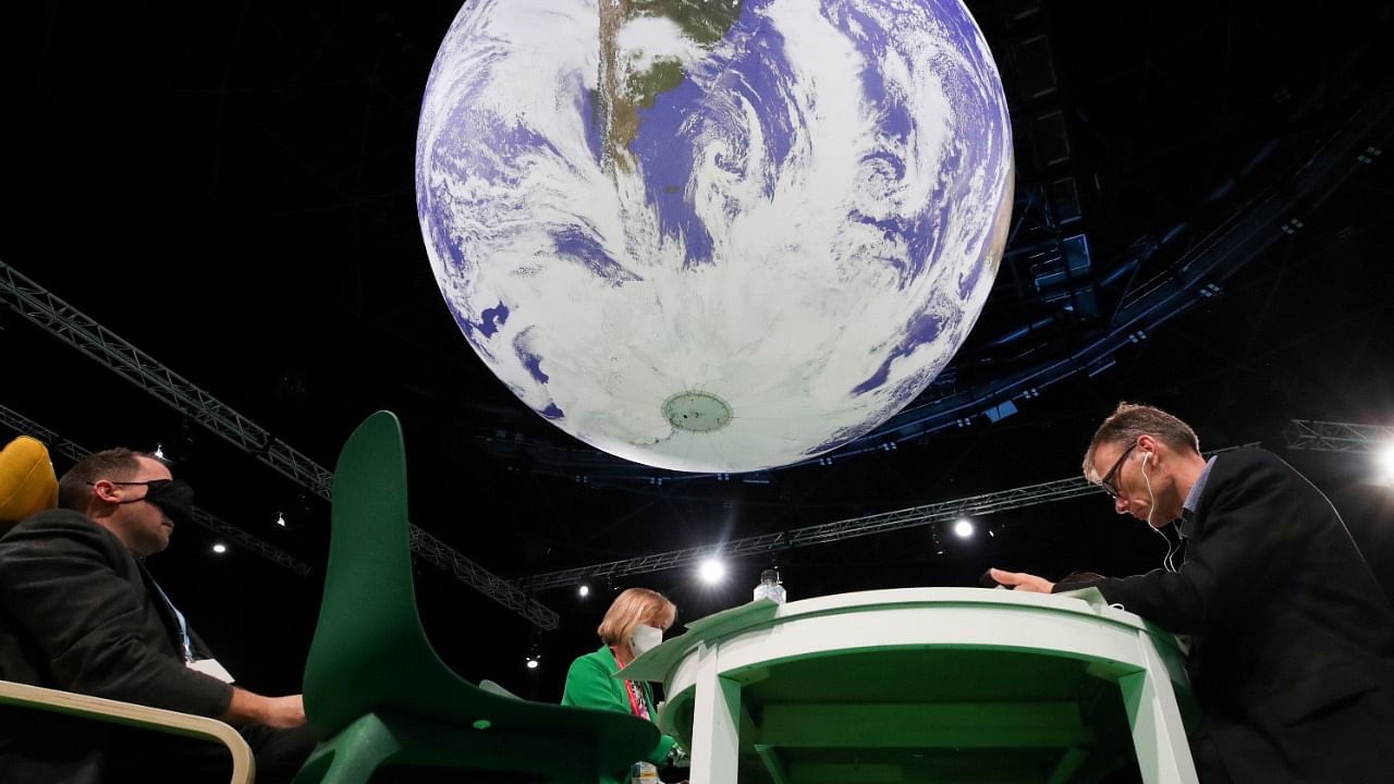 Delegates rest during the UN Climate Change Conference (COP26), in Glasgow, Scotland, Britain. Credit: Reuters File Photo