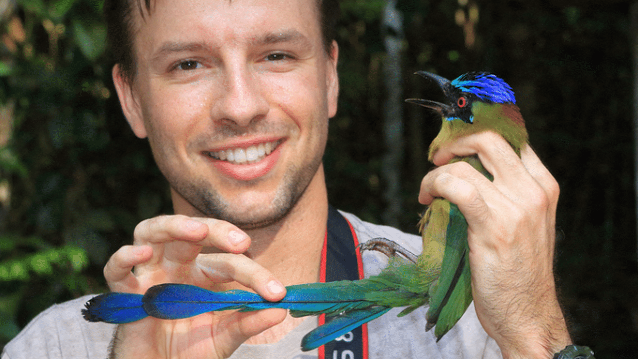 Researcher Vitek Jirinec holding an Amazonian Motmot. - Even the wildest parts of the Amazon untouched by humanity are being impacted by anthropogenic climate change. Credit: AFP Photo