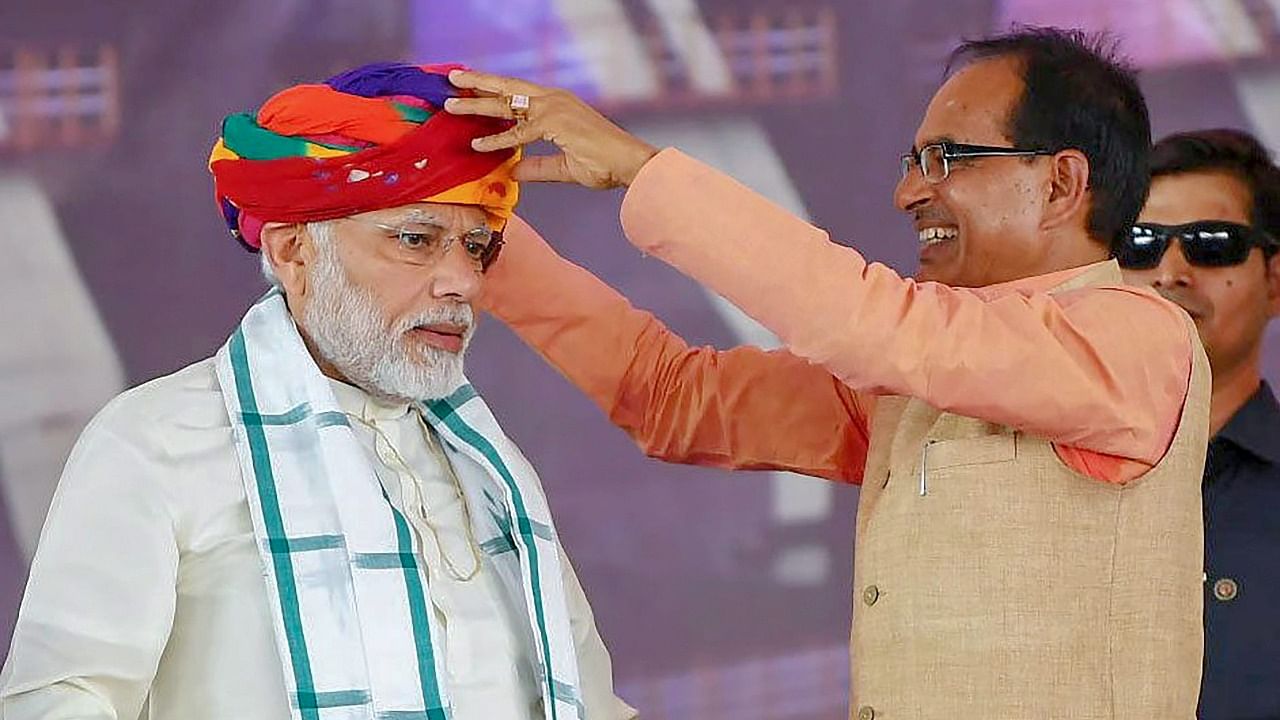 Prime Minister Narendra Modi being presented a turban by Madhya Pradesh Chief Minister Shivraj Singh Chouhan. Credit: PTI File Photo