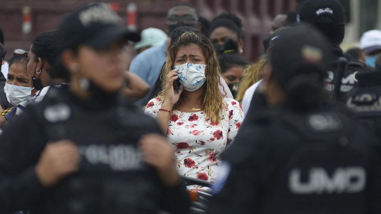 A relative of an inmate cries as she waits for news about her loved one after 58 convicts were killed in a riot at the Guayas 1 prison in Guayaquil, Ecuador. Credit: AFP Photo