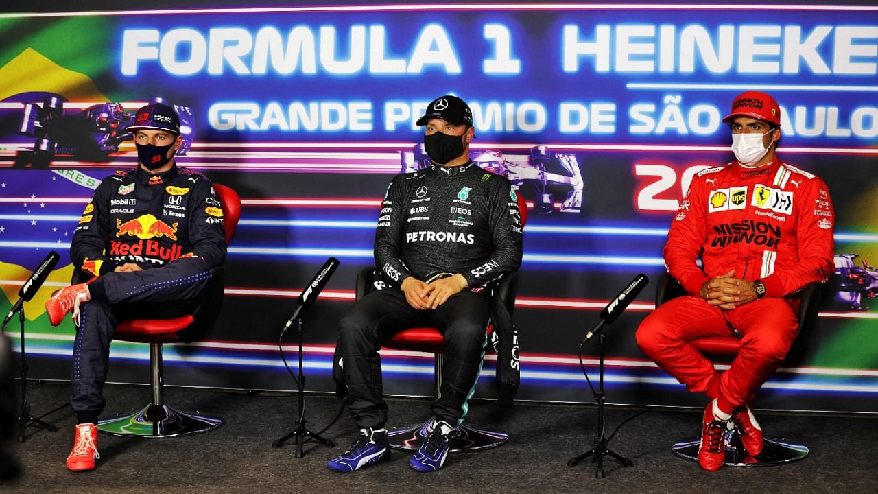 Mercedes' Finnish driver Valtteri Bottas (C), Red Bull's Dutch driver Max Verstappen (L) and Ferrari's Spanish driver Carlos Sainz Jr attend a press conference after obtaining the first, second and third positions respectively, in the sprint qualifying at the Autodromo Jose Carlos Pace, or Interlagos racetrack, in Sao Paulo. Credit: AFP Photo