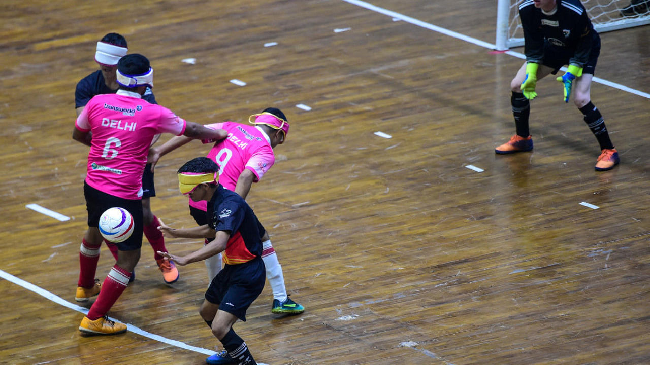 Blind players of Delhi and Uttarakhand (in black t-shirts) during their futsal match of the Hero Futsal Club Championship 2021 at IG Stadium, in New Delhi, Thursday, Nov. 11, 2021. credit: PTI Photo