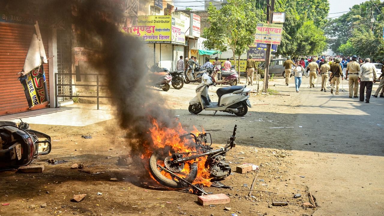 A vehicle set on fire by a mob during a bandh organised by BJP, in Amravati. Credit: PTI Photo
