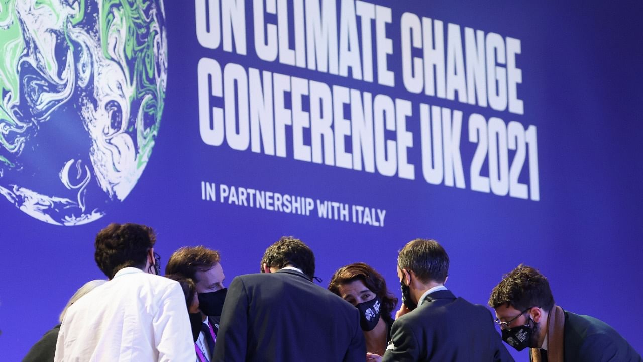 Delegates talk during the UN Climate Change Conference (COP26) in Glasgow, Scotland, Britain November 13, 2021. Credit: Reuters File Photo