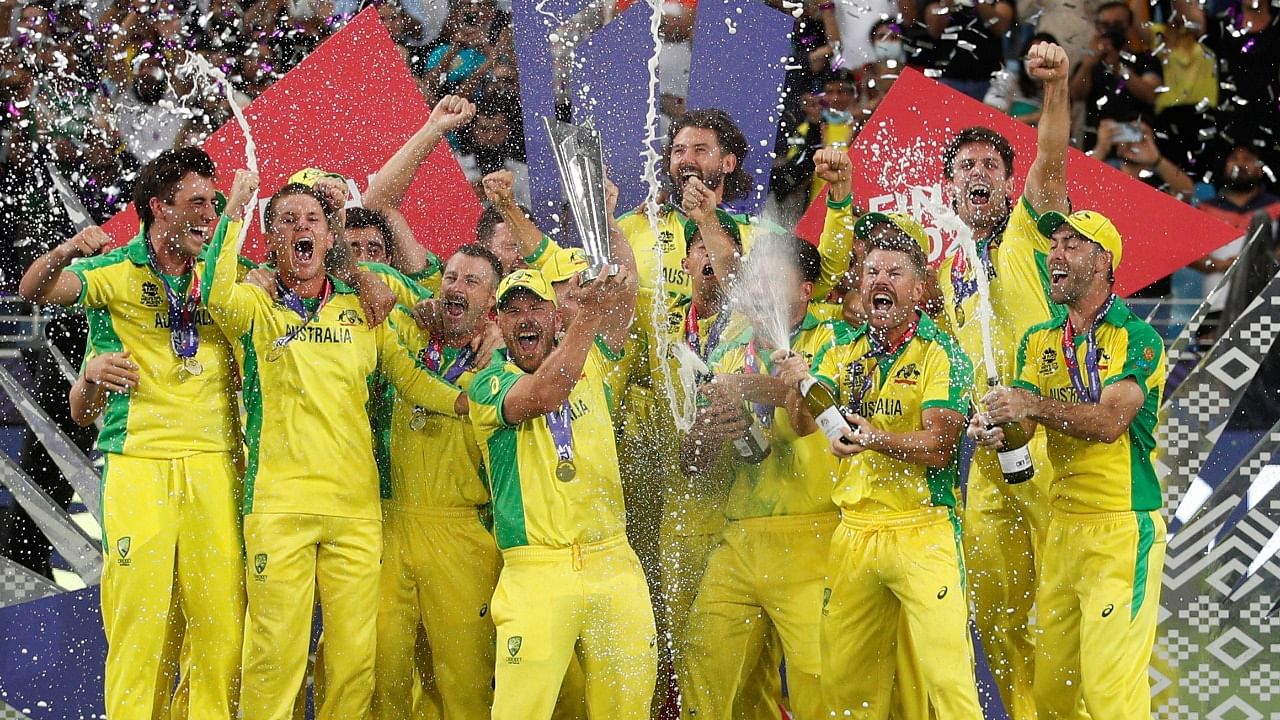 Australia captain Aaron Finch celebrates with the trophy and teammates after winning the ICC Men's T20 World Cup. Credit: Reuters Photo