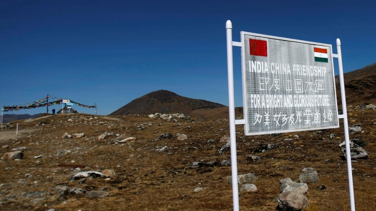 A signboard is seen from the Indian side of the Indo-China border at Bumla, in the northeastern Indian state of Arunachal Pradesh. Credit: Reuters Photo