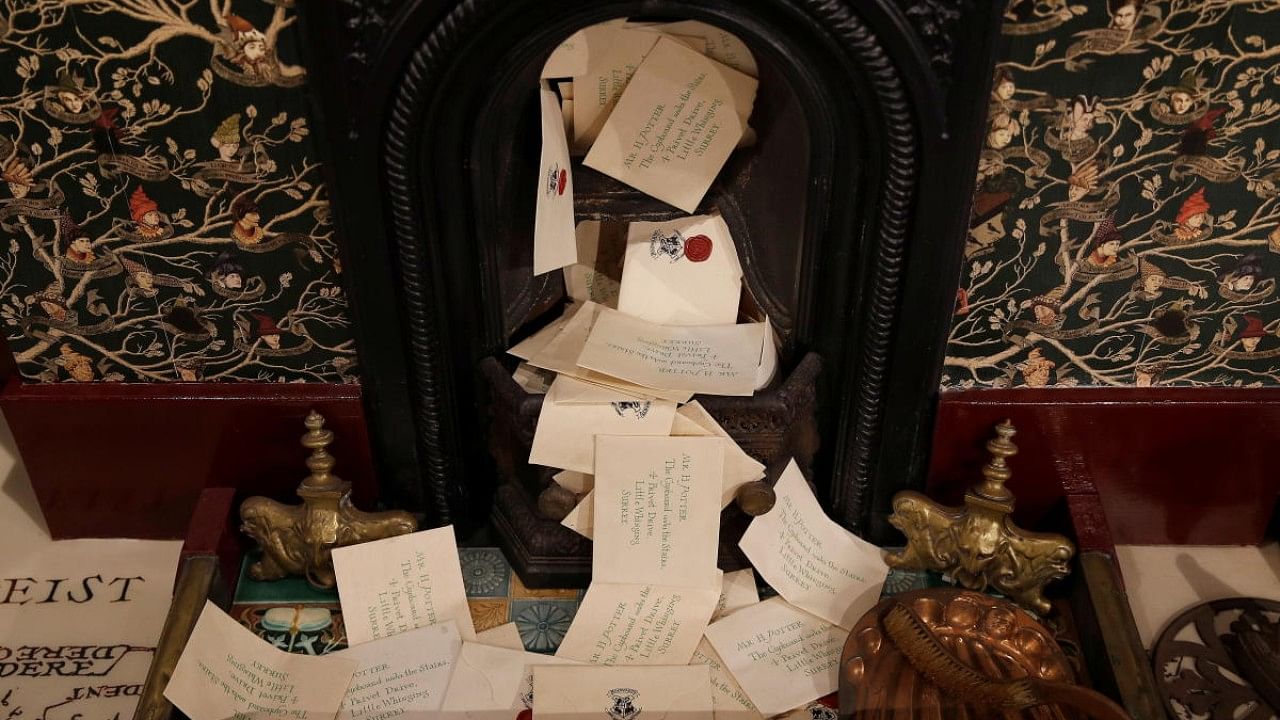 Letter props created by artists Eduardo Lima and Miraphora Mina for the movie Harry Potter and the Philosopher's Stone, are seen displayed in a fireplace at their store in London. Credit: Reuters Photo