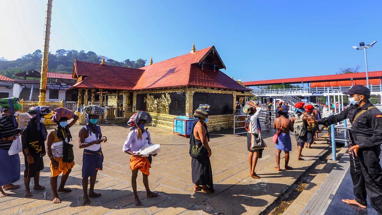 A file photo of devotees standing in a queue to enter Sabarimala Temple, at Sabarimala. Credit: PTI Photo