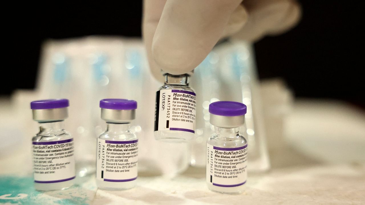 A nurse picks up a vial containing Pfizer's Covid-19 vaccine. Credit: AFP File Photo