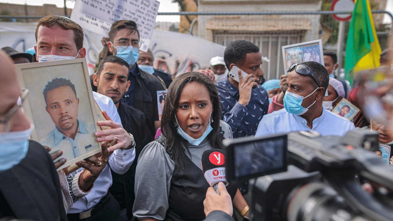 Israel's Minister of Immigration and Absorption Pnina Tamano-Shata (C) speaks before a camera as she meets with members from the Israeli-Ethiopian community gathering for a demonstration demanding the rescue of their relatives left behind amidst the conflict in Ethiopia. Credit: AFP Photo