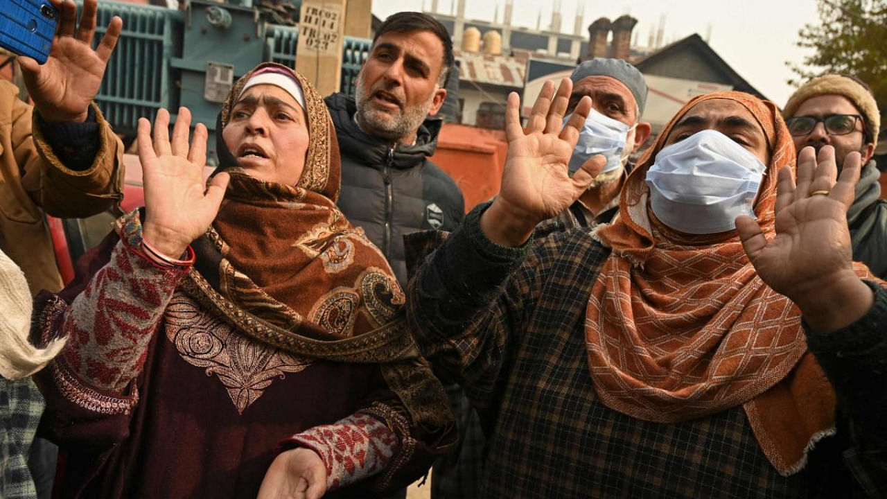 Relatives of Mudasir Gul, one of the two civilians killed during a police encounter with suspected militants the night before, mourn during a protest accusing police forces to use the civilians as human shields. Credit: AFP Photo