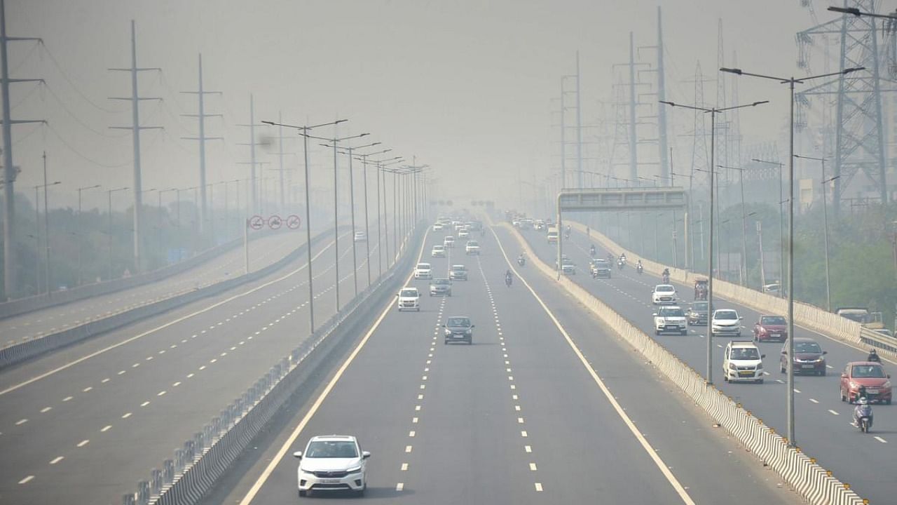 Vehicles ply on Delhi-Meerut Expressway amid low visibility due to a thick layer of smog in Ghaziabad. Credit: PTI Photo