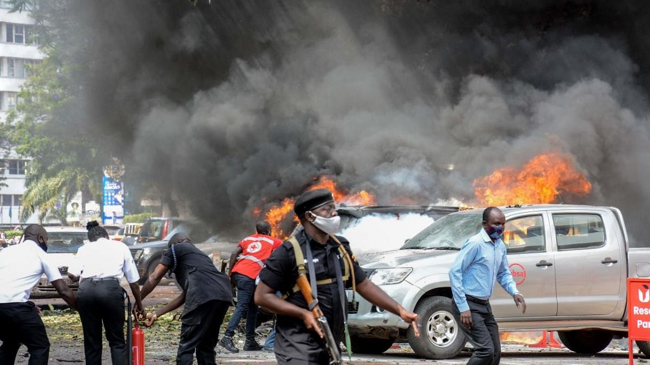 The explosions occurred in the central business district of Kampala near the central police station and the entrance to parliament, police said. Credit: AFP Photo
