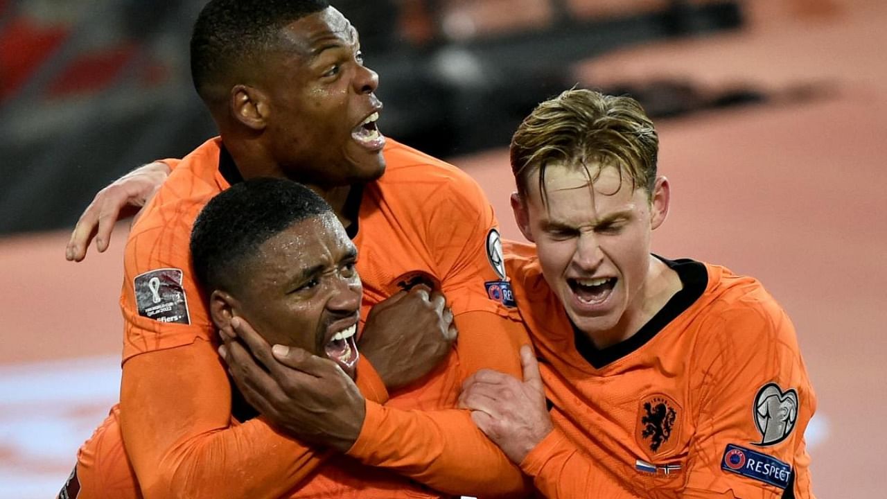 Netherlands' forward Steven Bergwijn (L) celebrates with teammates after scoring his team's first goal during the FIFA World Cup Qatar 2022 qualifying round Group G football match between Netherlands and Norway at the Feijenoord stadium in Rotterdam. Credit: AFP Photo