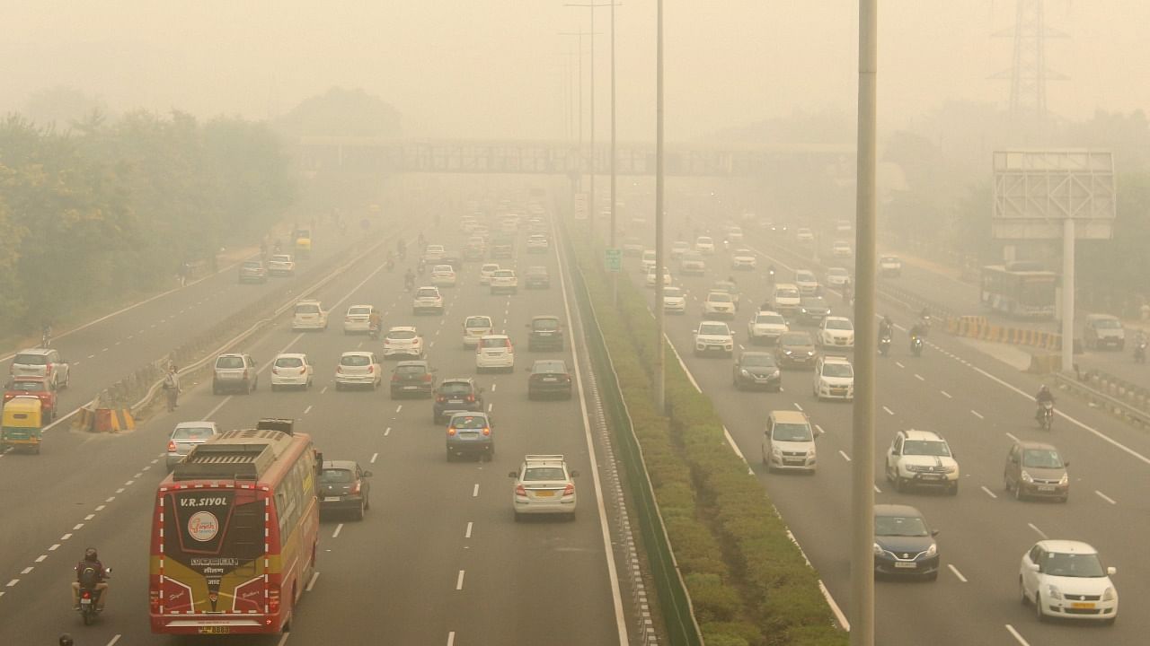 Vehicles ply amid low visibility due to a thick layer of smog at Delhi-Gurugram Expressway in Gurugram. Credit: PTI File Photo