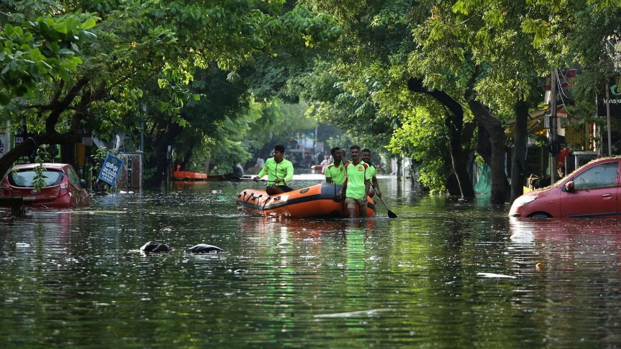 Members of police move in a boat through a water-logged neighbourhood looking for residents to evacuate them to safer place after heavy rains in Chennai. Credit: Reuters Photo
