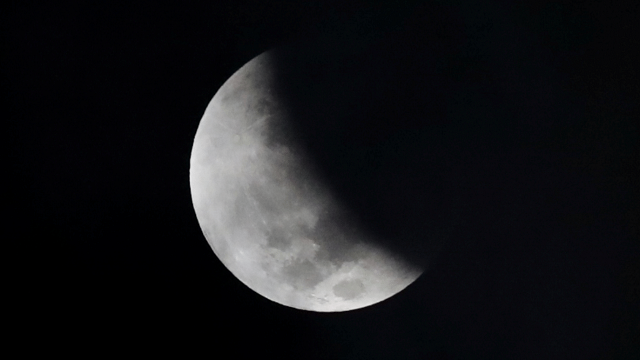 A shadow falls on the moon as it undergoes a partial lunar eclipse. Credit: Reuters Photo